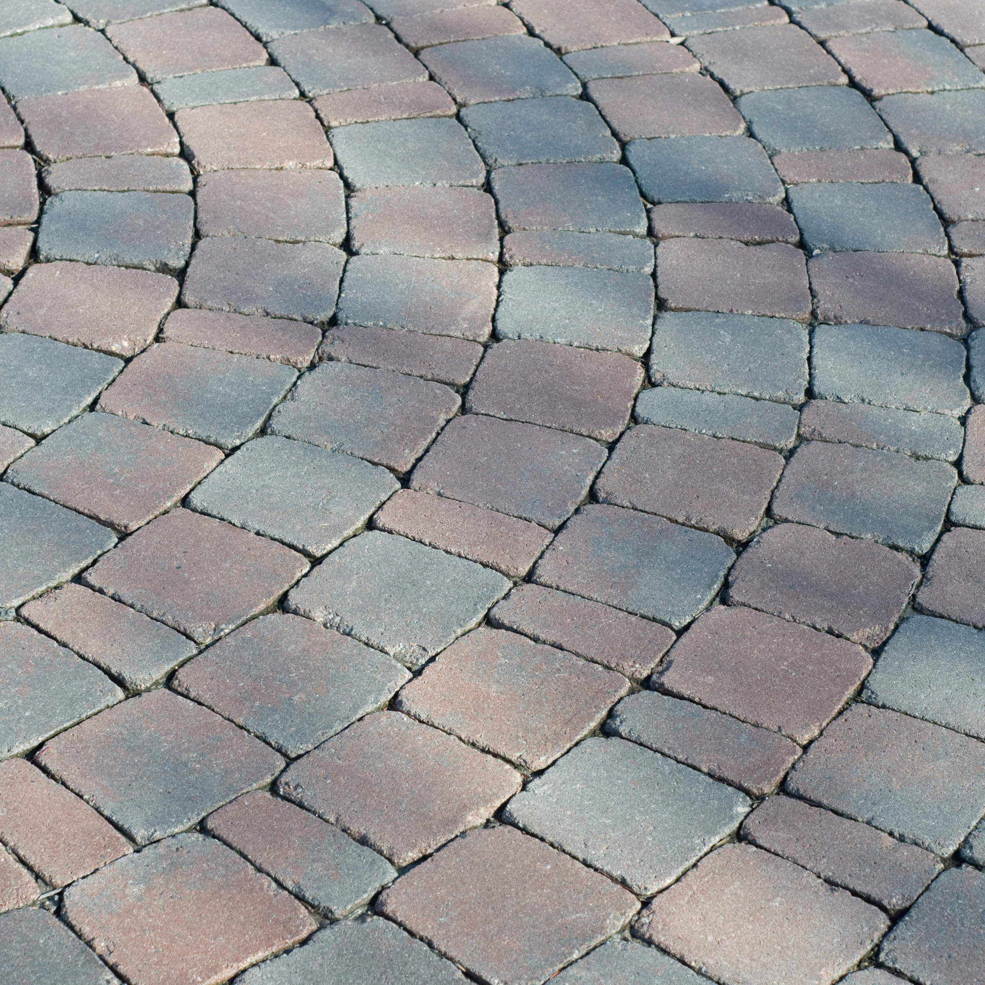 A close up of a brick deck with a diagonal pattern
