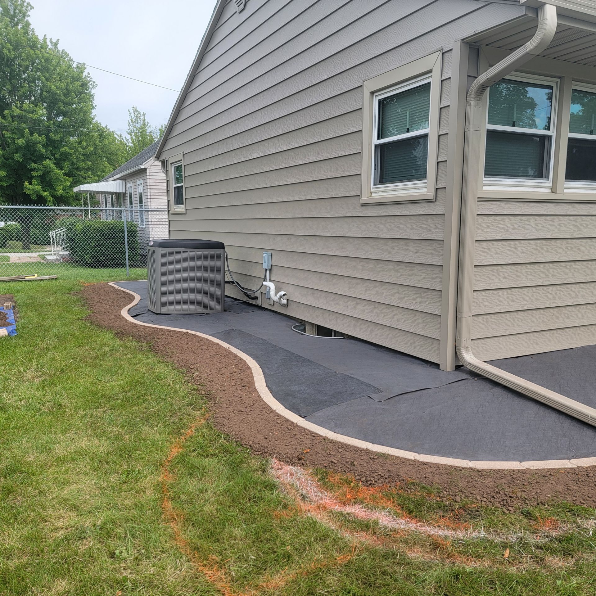 Raised grated area next to a waterproofed house