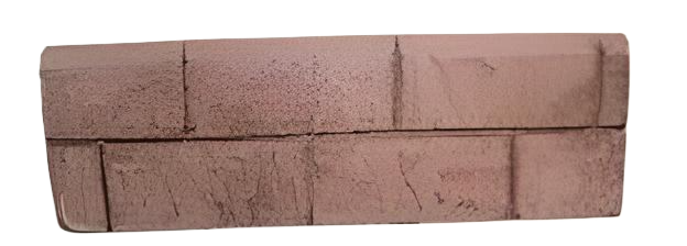 A small, rectangular brick-like object in shades of brown against a white background.