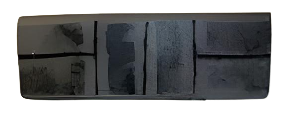 A dark rectangular object with multiple darker rectangular patches and black lines.