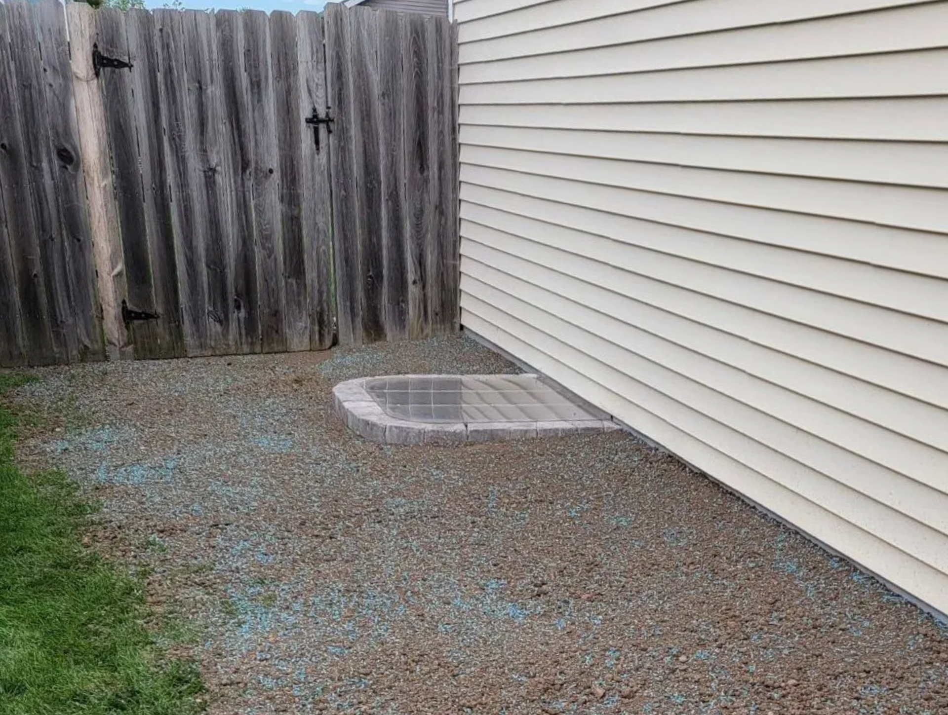 completed window well with grading and grass seed 