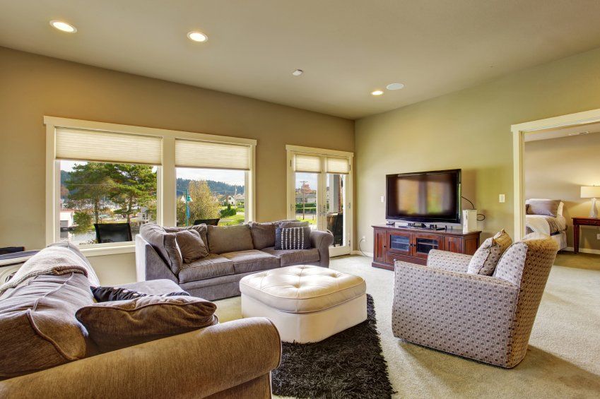 Sandhills Living room with carpet, windows, and water view.