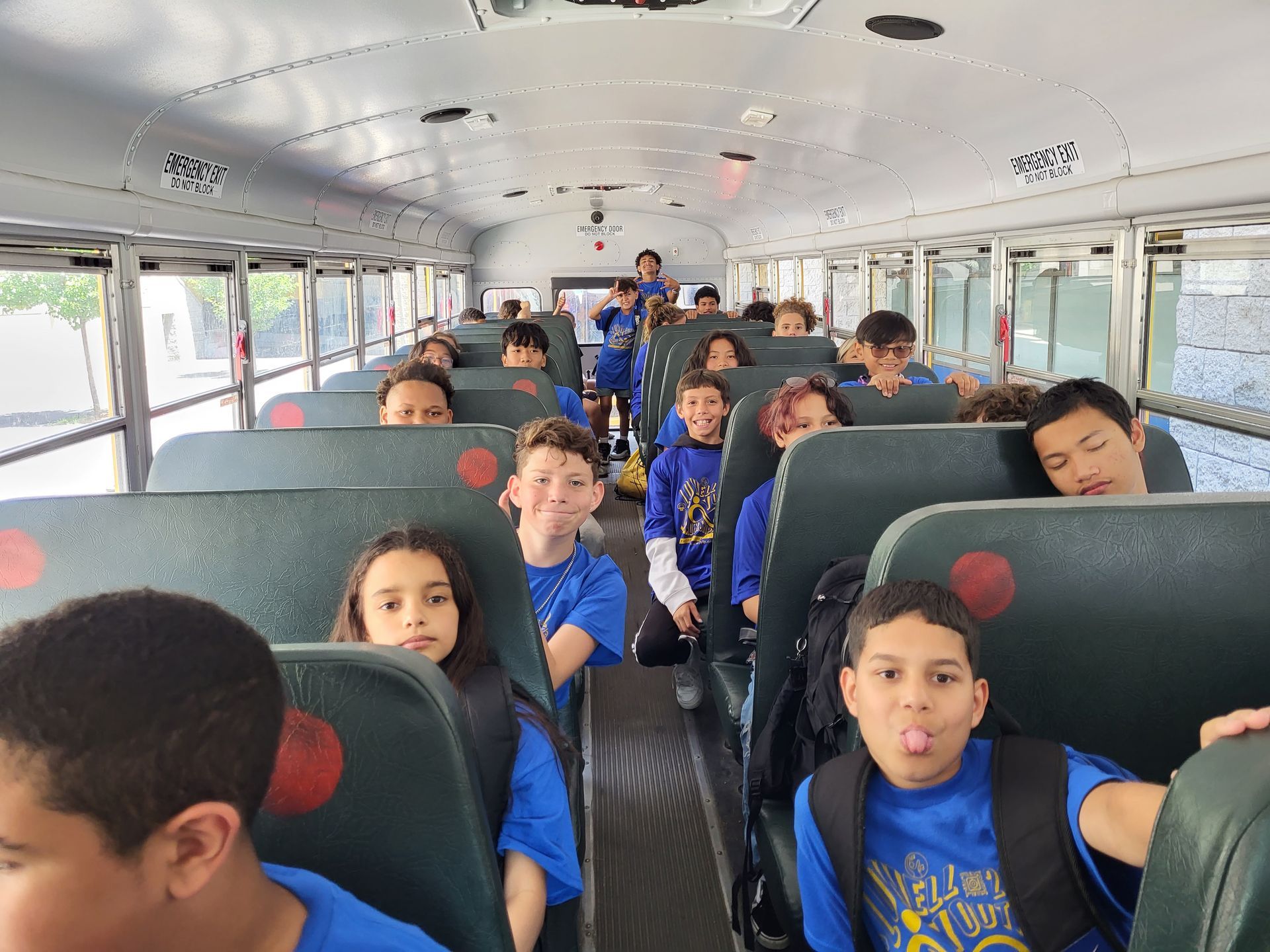 A group of children are sitting on a school bus.