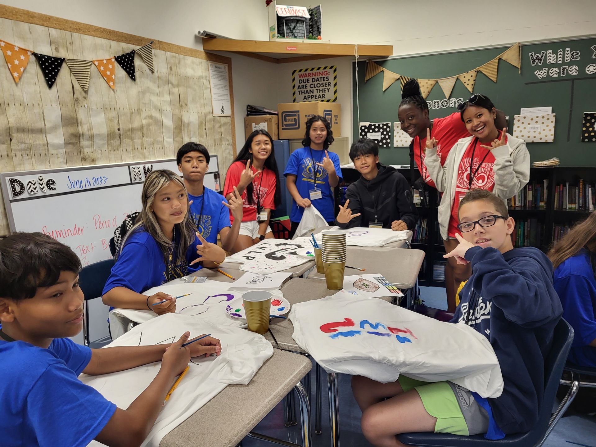 A group of children are sitting around a table in a classroom.