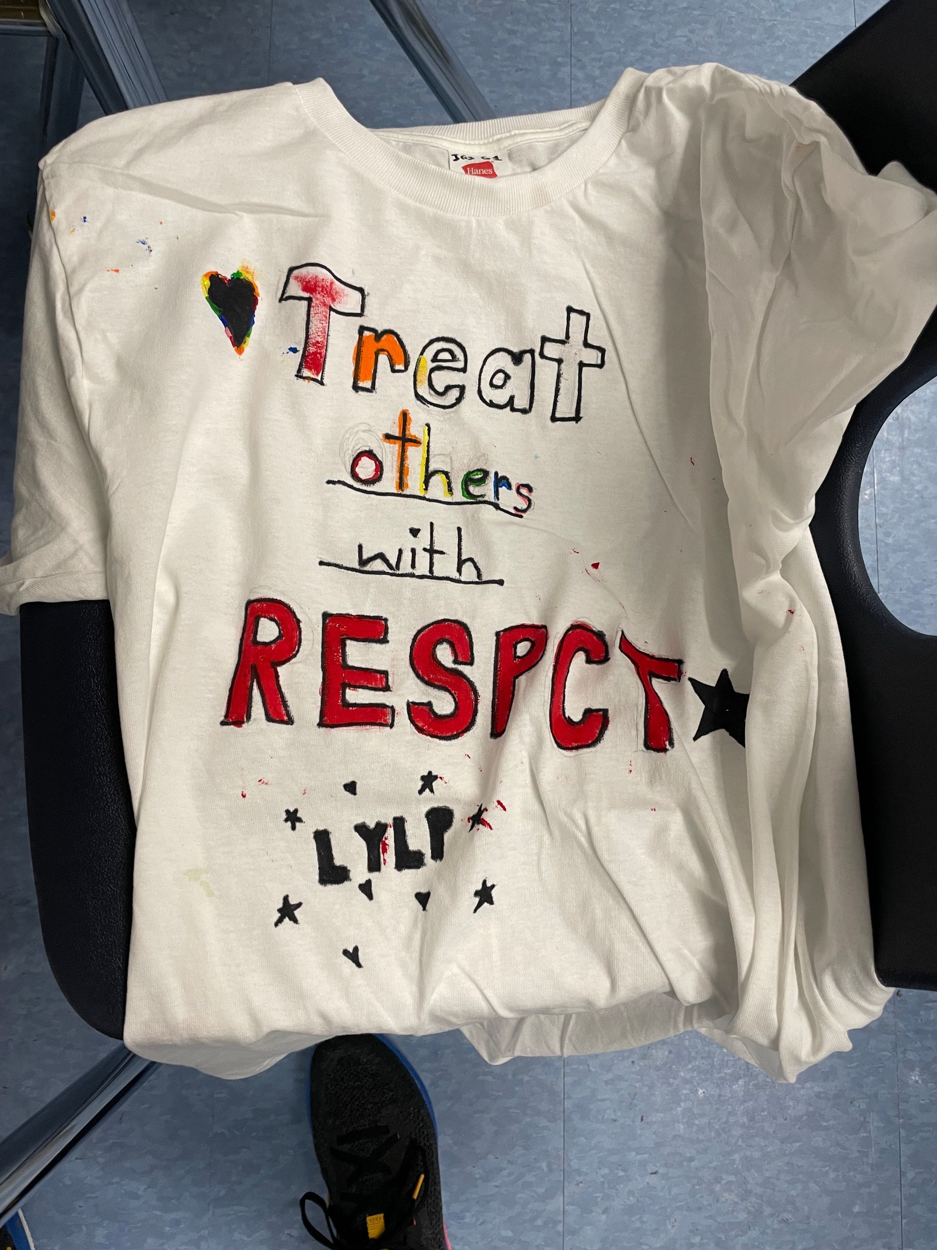 A white t-shirt that says treat others with respect