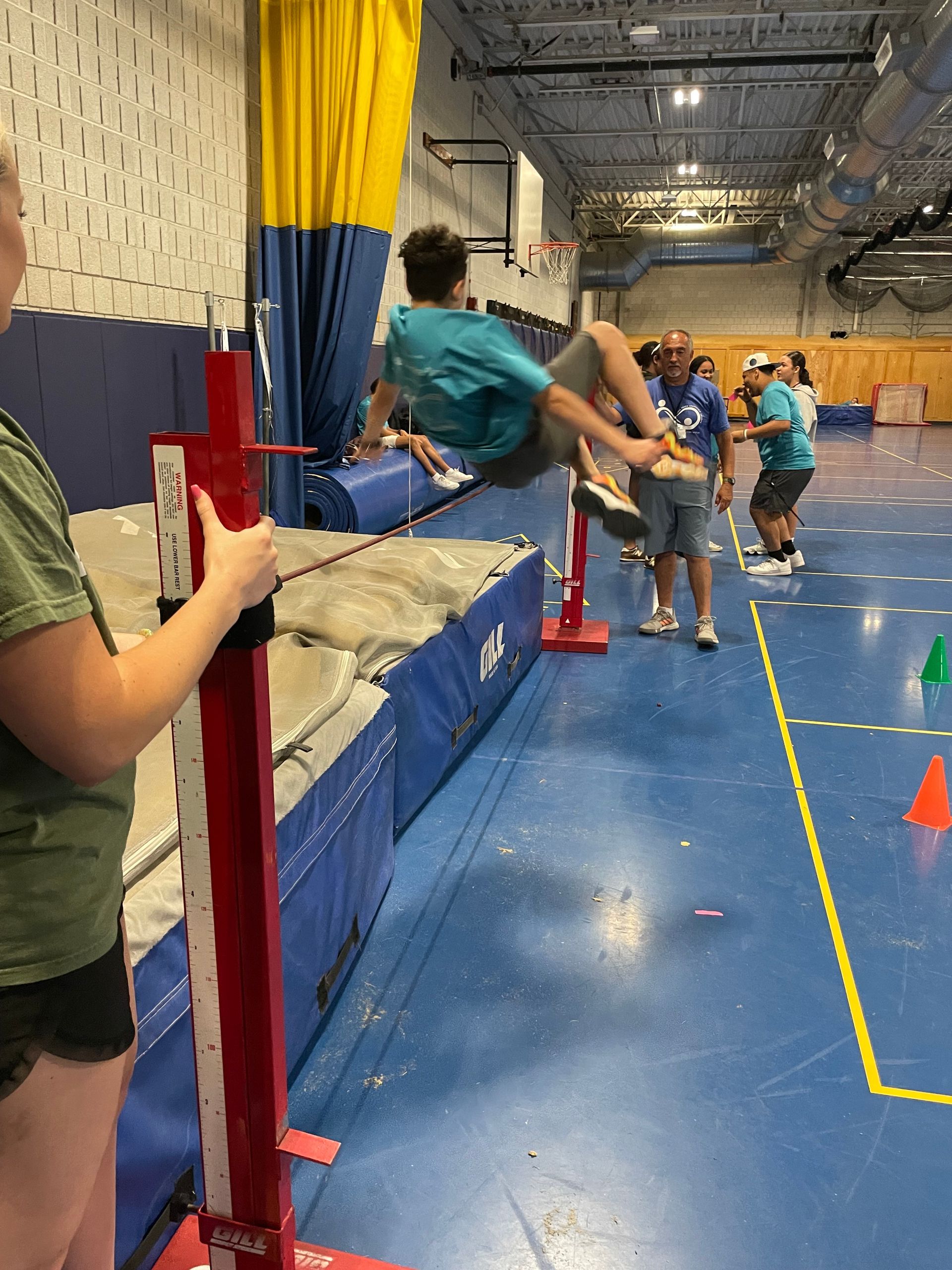 A group of people are doing exercises on a gym floor