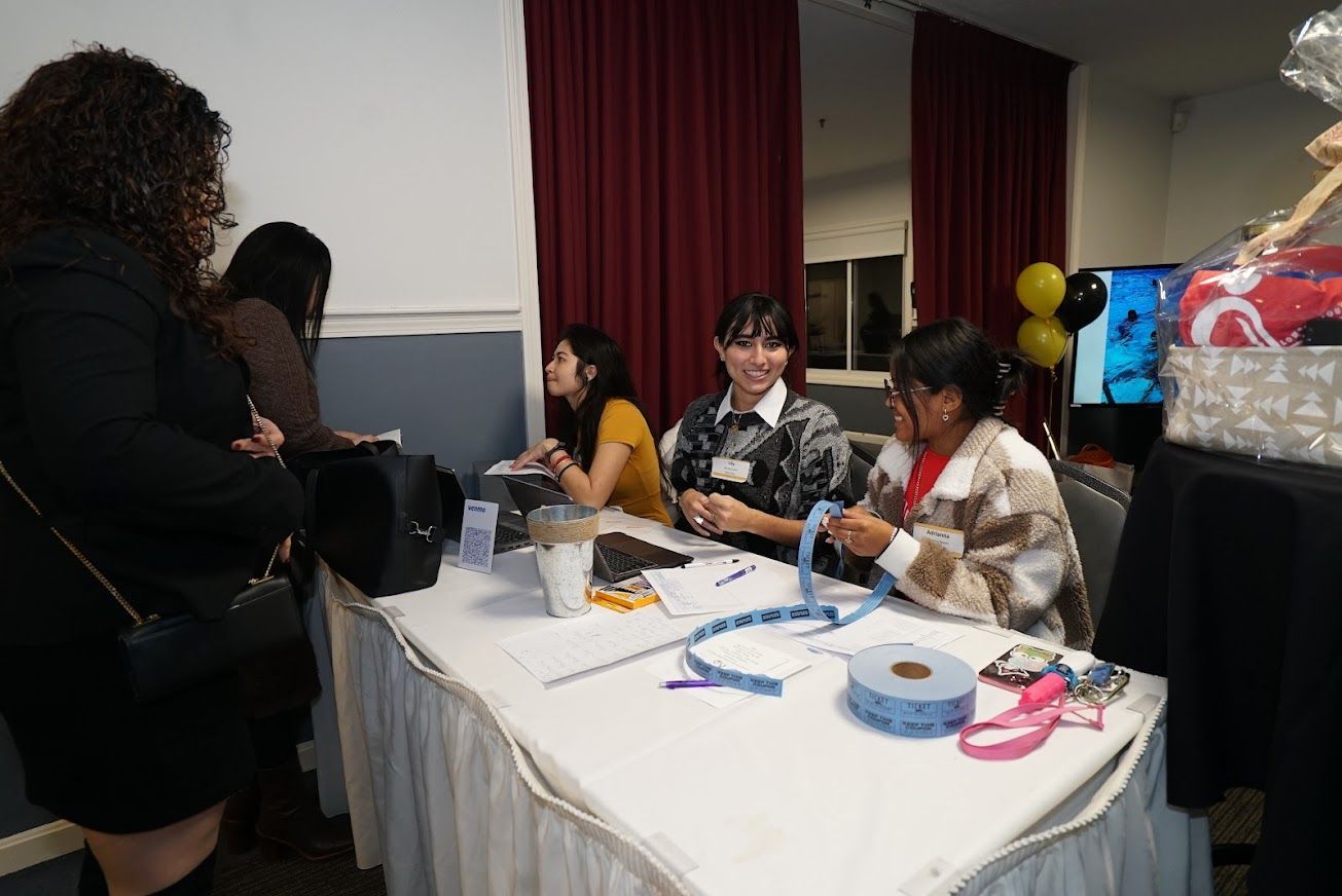 A group of women are sitting at a table in a room.