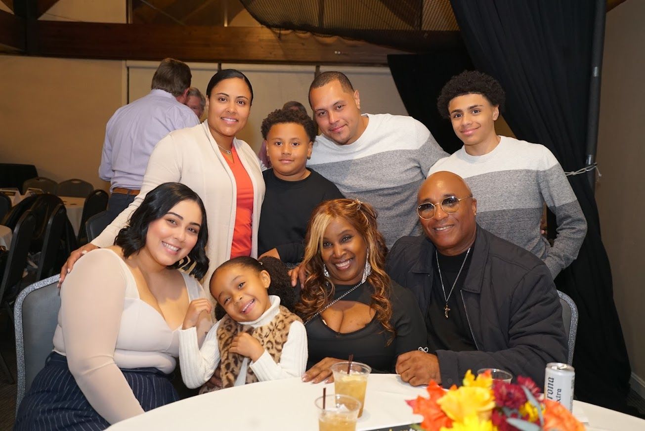 A group of people are posing for a picture at a table.