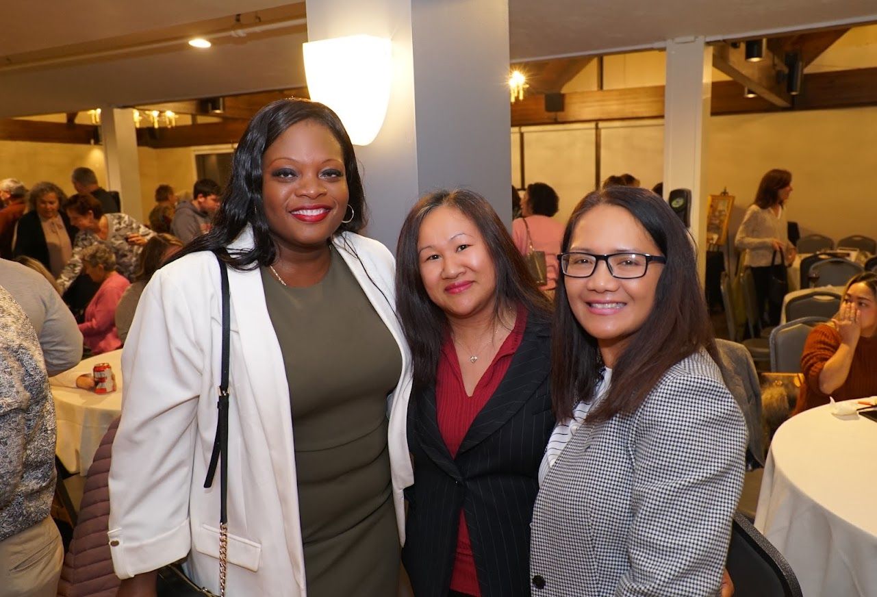 Three women are posing for a picture together in a room.