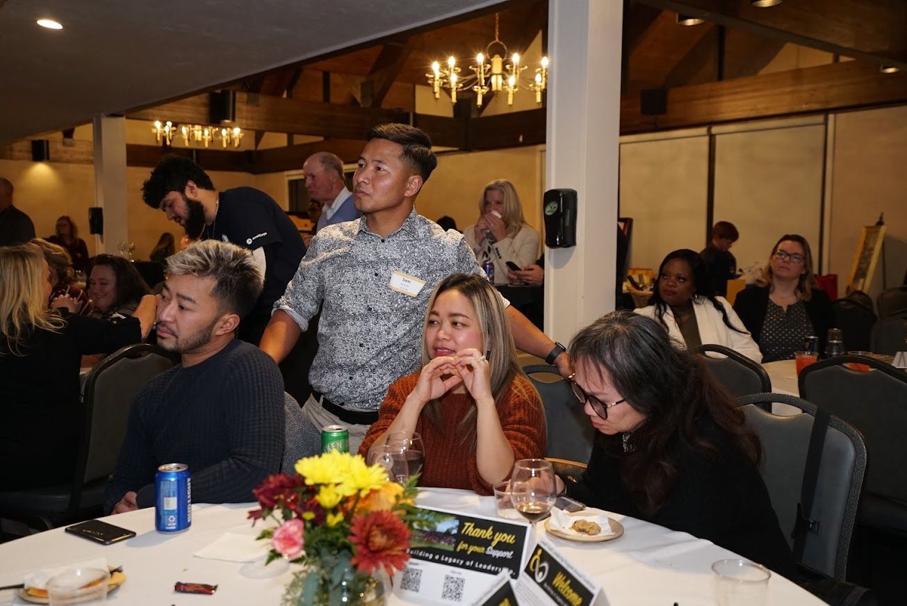 A group of people are sitting at tables in a room.