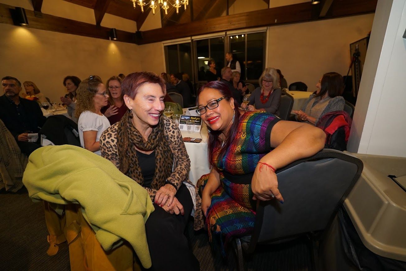 A group of people are sitting at tables in a room.