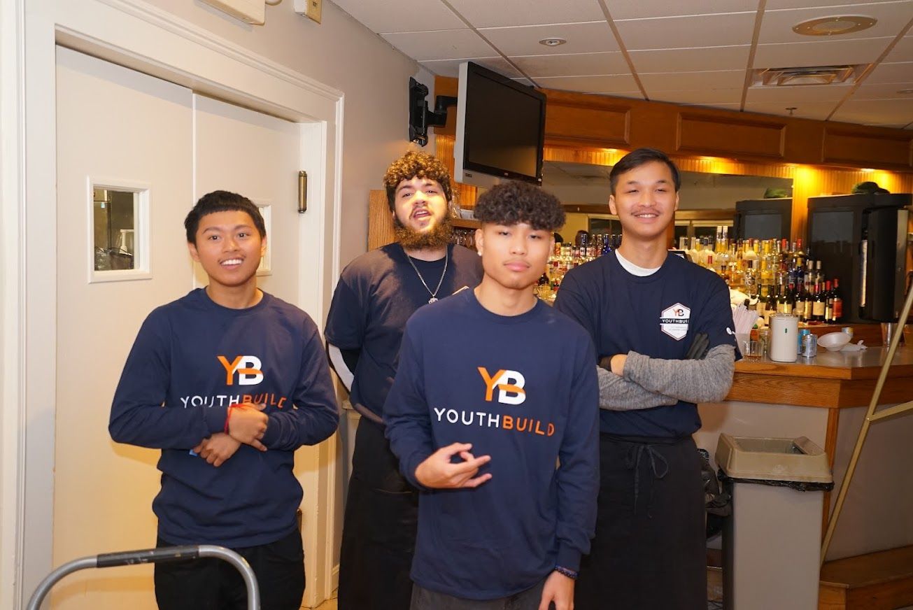 A group of young men are posing for a picture in a restaurant.