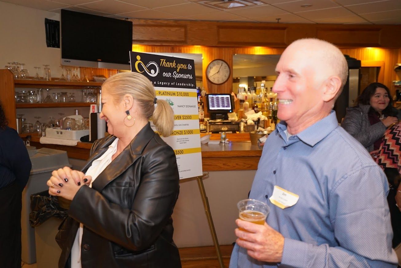 A man and a woman are standing next to each other in a room.