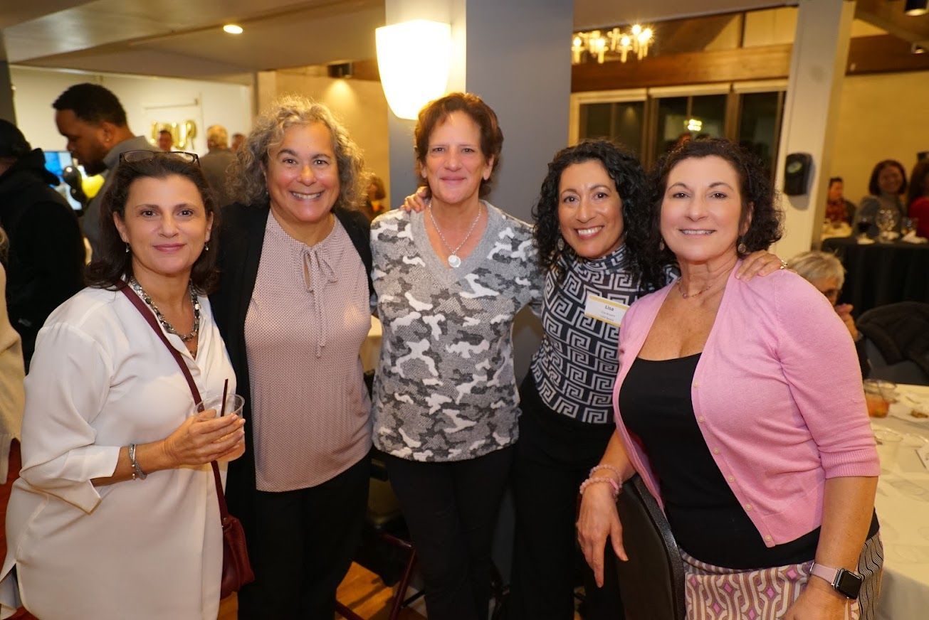 A group of women are posing for a picture together