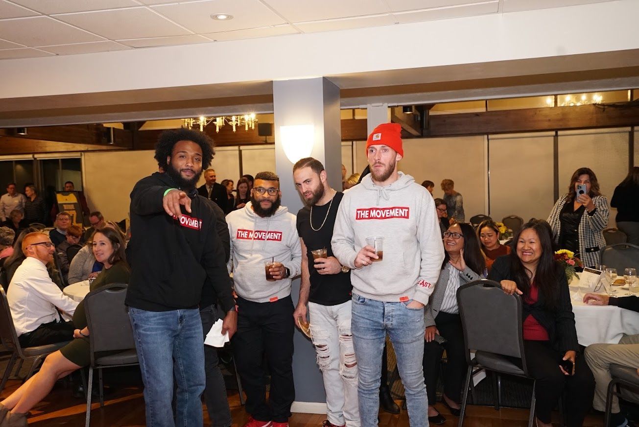 A group of men are standing next to each other in a room.