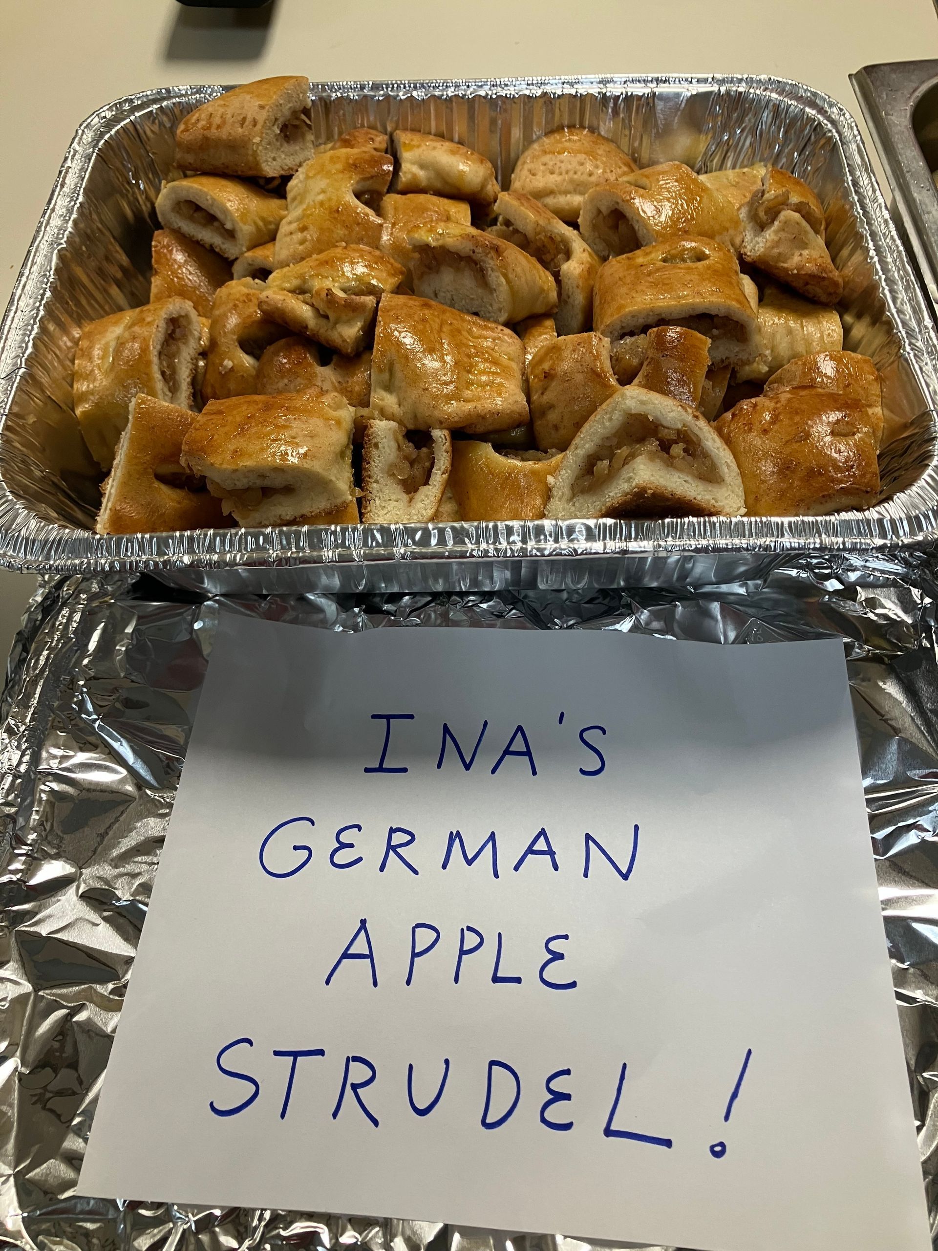 A tray of german apple strudels with a sign that says ina 's german apple strudel !