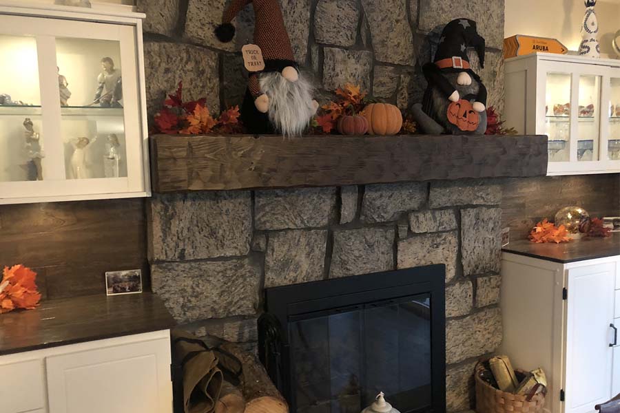 Autumn decorated rustic mantel and stone fireplace made from solid timber wood and hand hewn