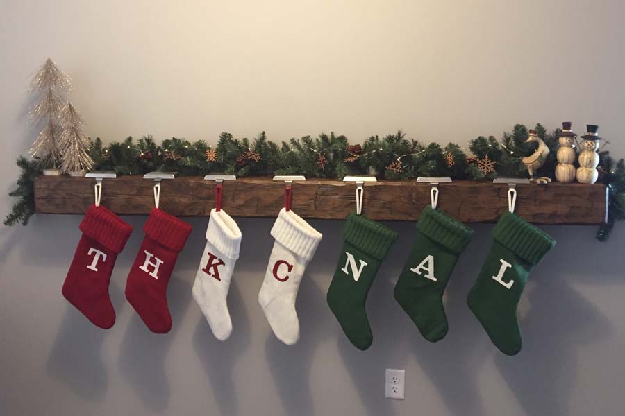 Christmas stockings on solid timber wood mantel beam that is hand hewn
