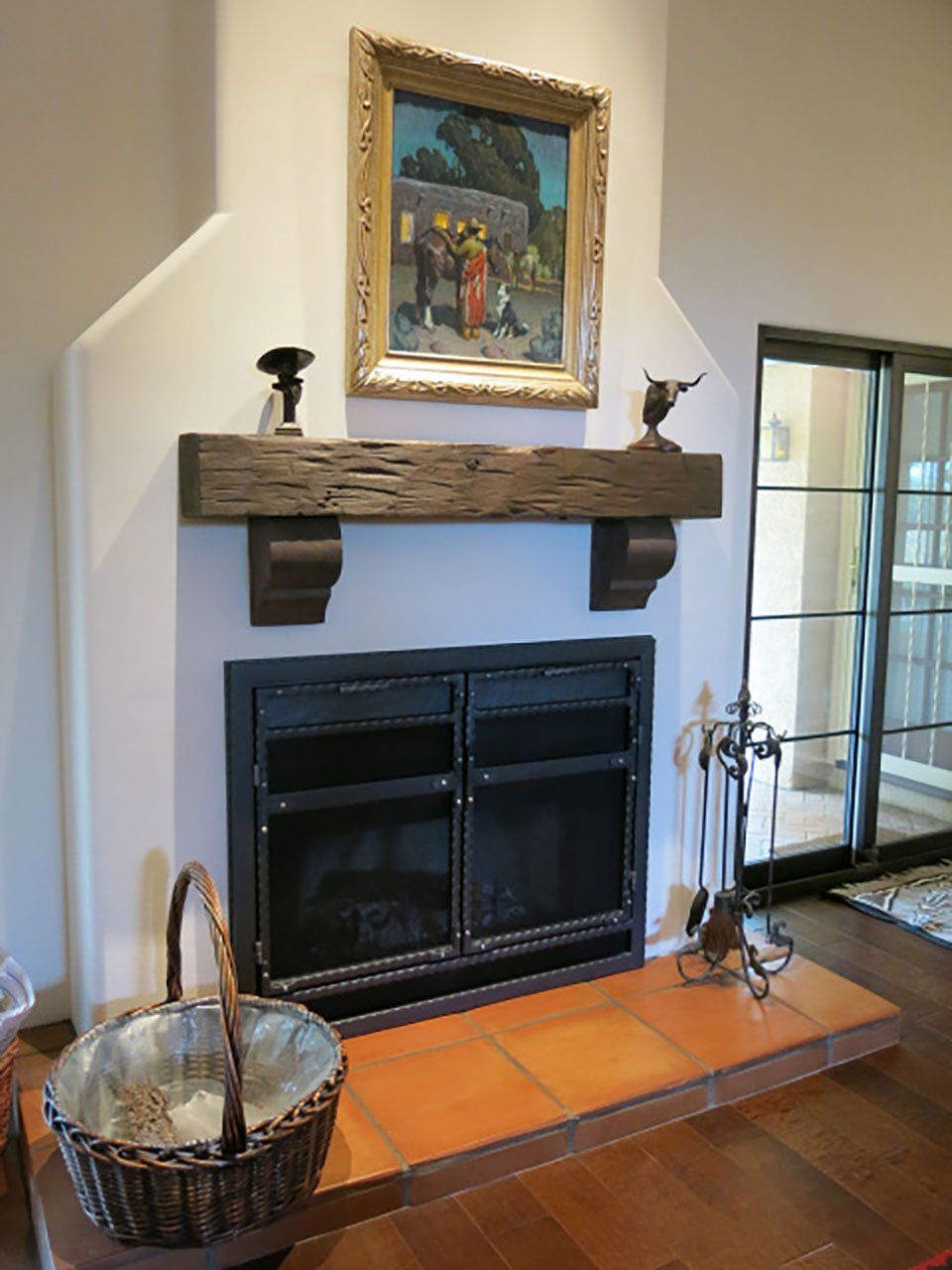 Hand hewn and weathered solid wood fireplace mantel in winter