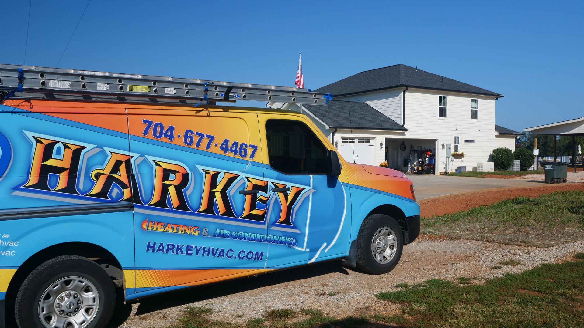 Harkey roofing van parked near a house with a new roof, sunny day.