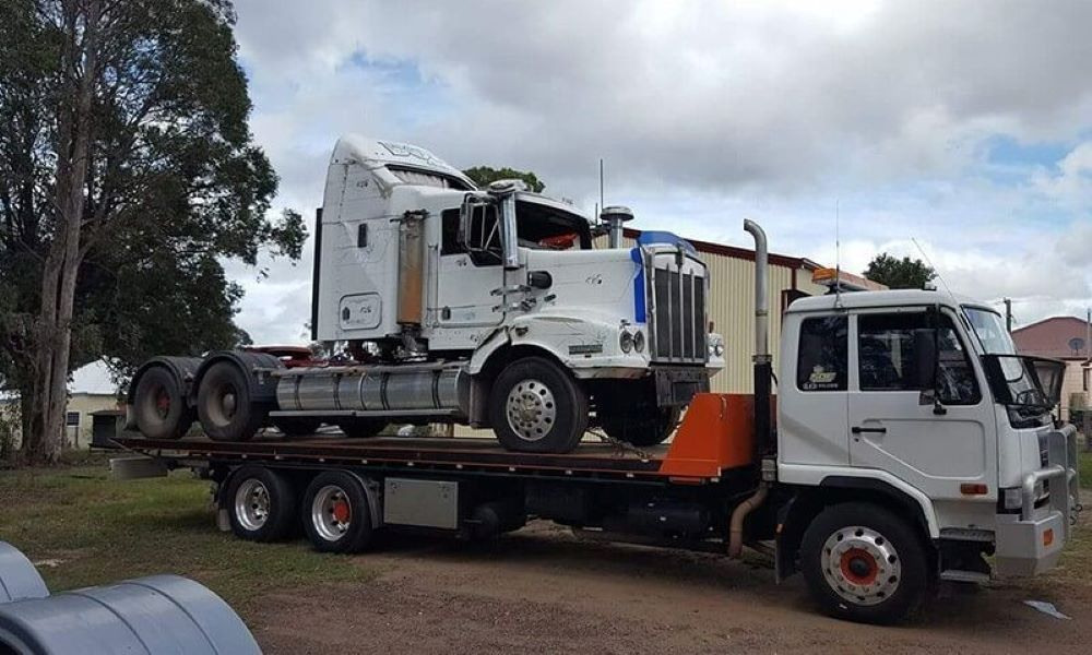 A Semi Truck Is Sitting on Top of A Flatbed Tow Truck — Easylift Towing NSW Pty Ltd In Swansea, QLD