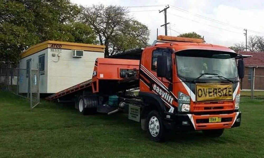 An Orange Tow Truck with A Yellow Sign on The Front that Says Oversize — Easylift Towing NSW Pty Ltd In Swansea, QLD