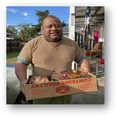 A man is holding a box that says poultry on it