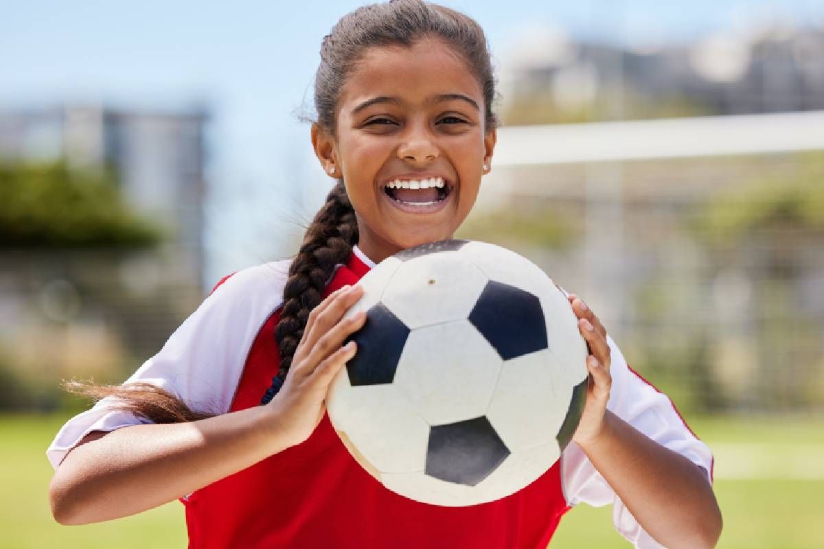 A child playing soccer who has the protection of ScholarGuard™