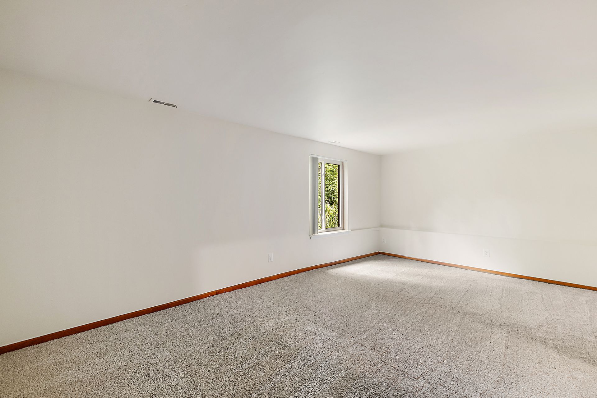 There is a window in the corner of the room.