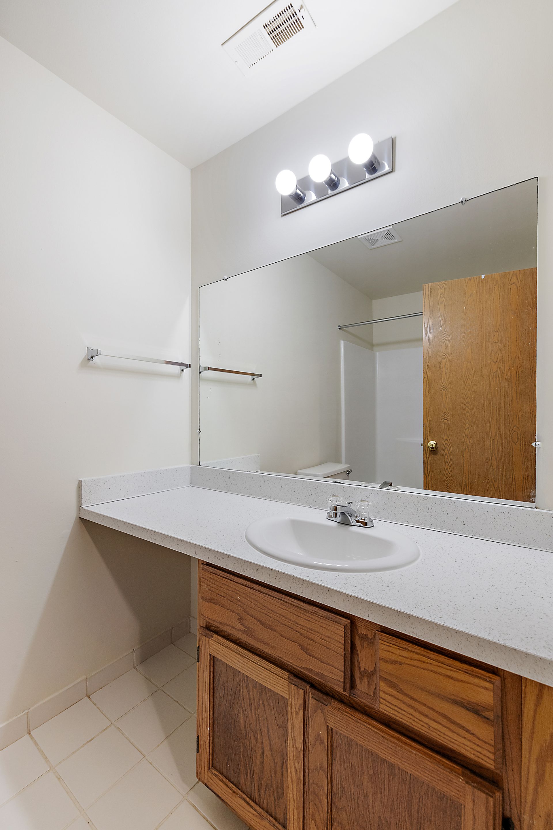 A bathroom with a sink and a large mirror