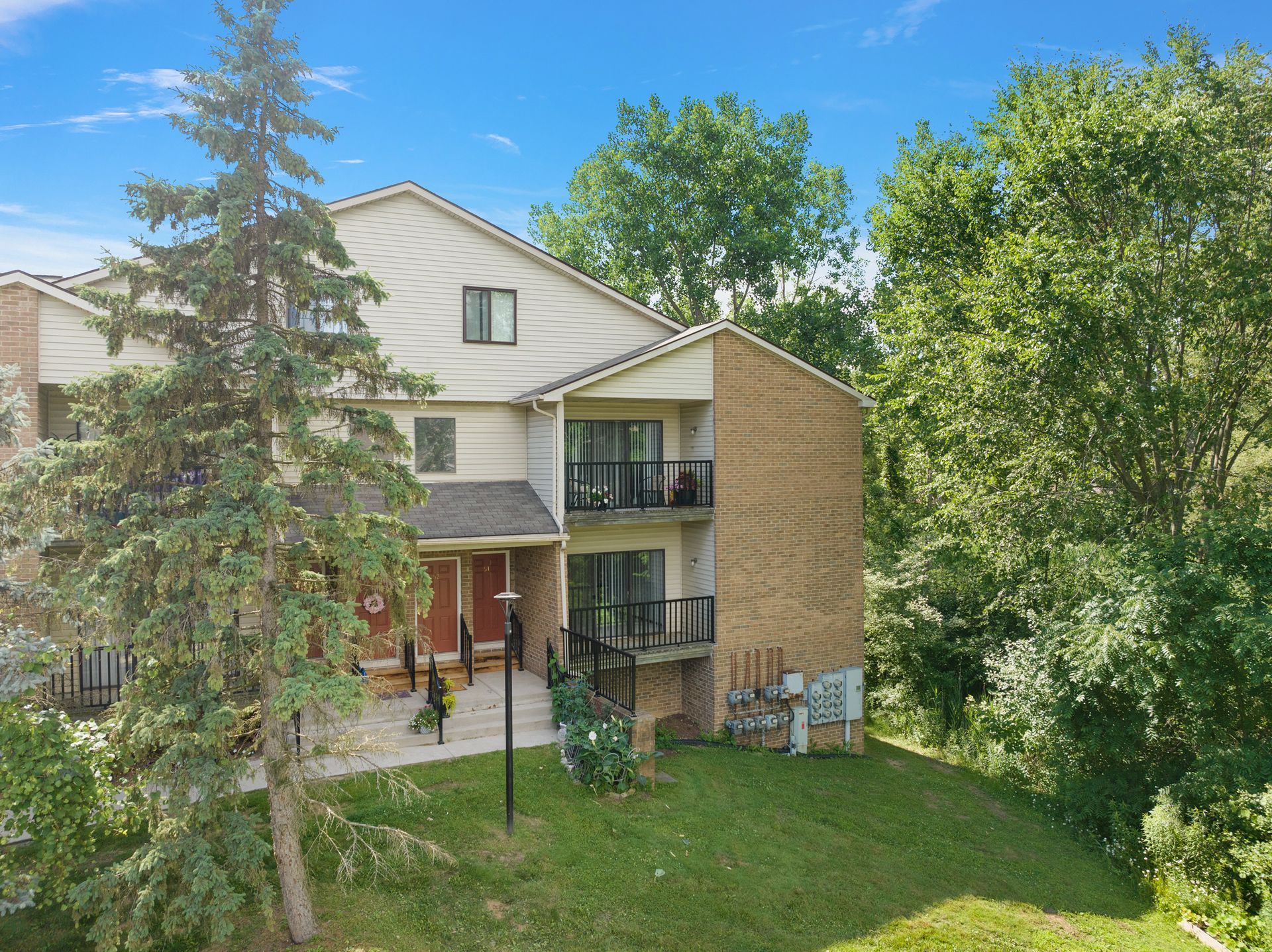 An aerial view of a large apartment building surrounded by trees.