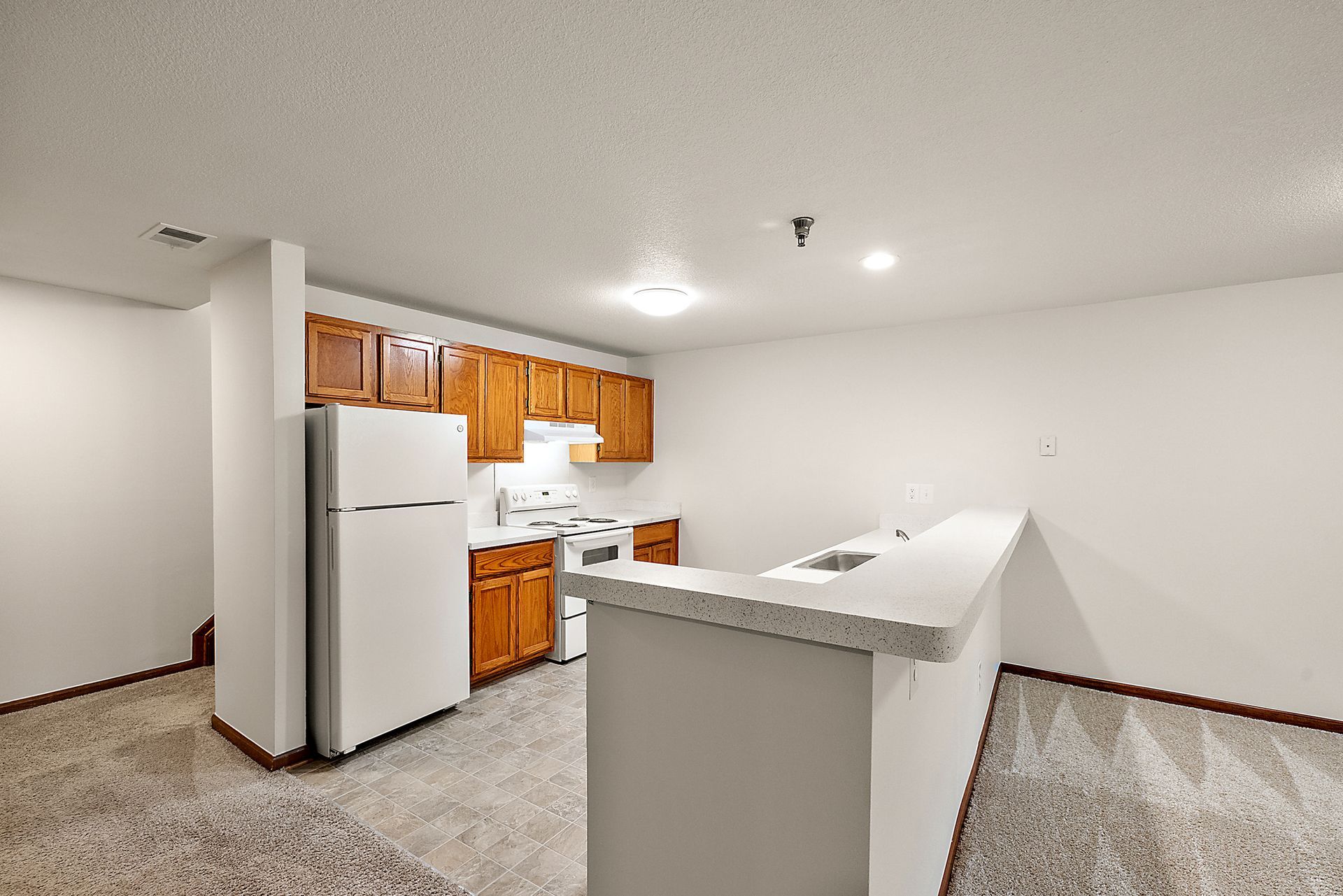 A kitchen with a refrigerator , stove , and sink.