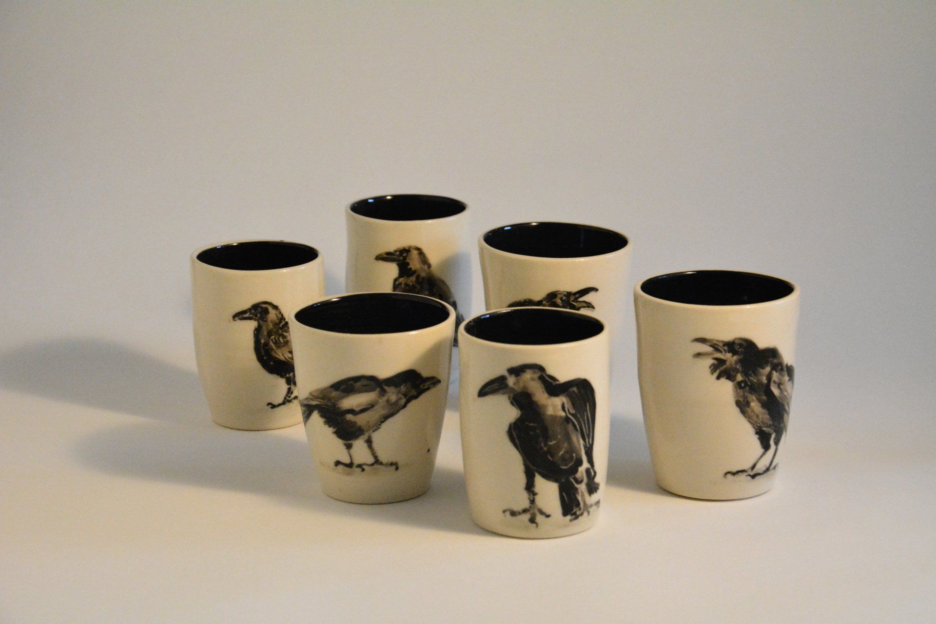 A group of shot glasses with birds on them