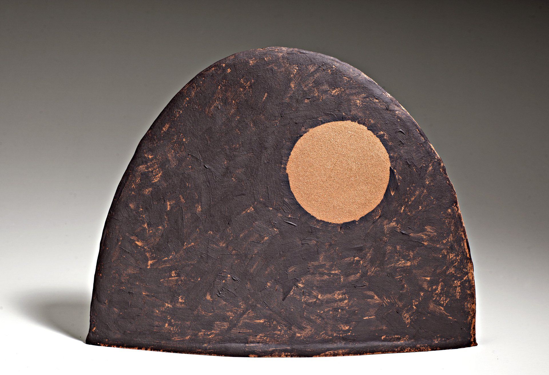 A piece of wood with a circle in the middle