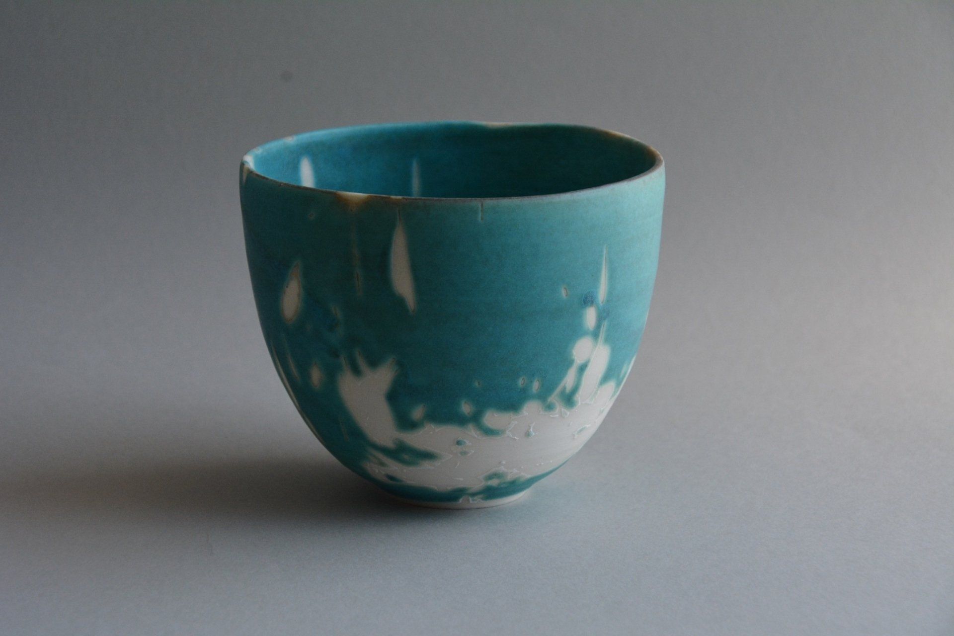 A blue and white bowl is sitting on a table.