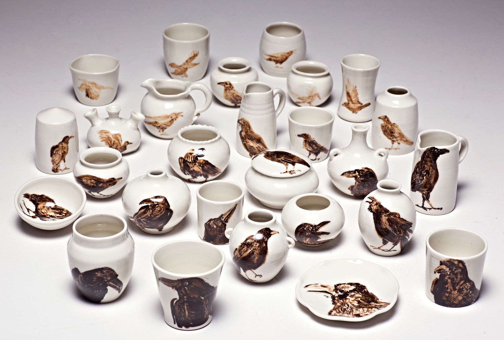 A collection of ceramics with birds painted on them