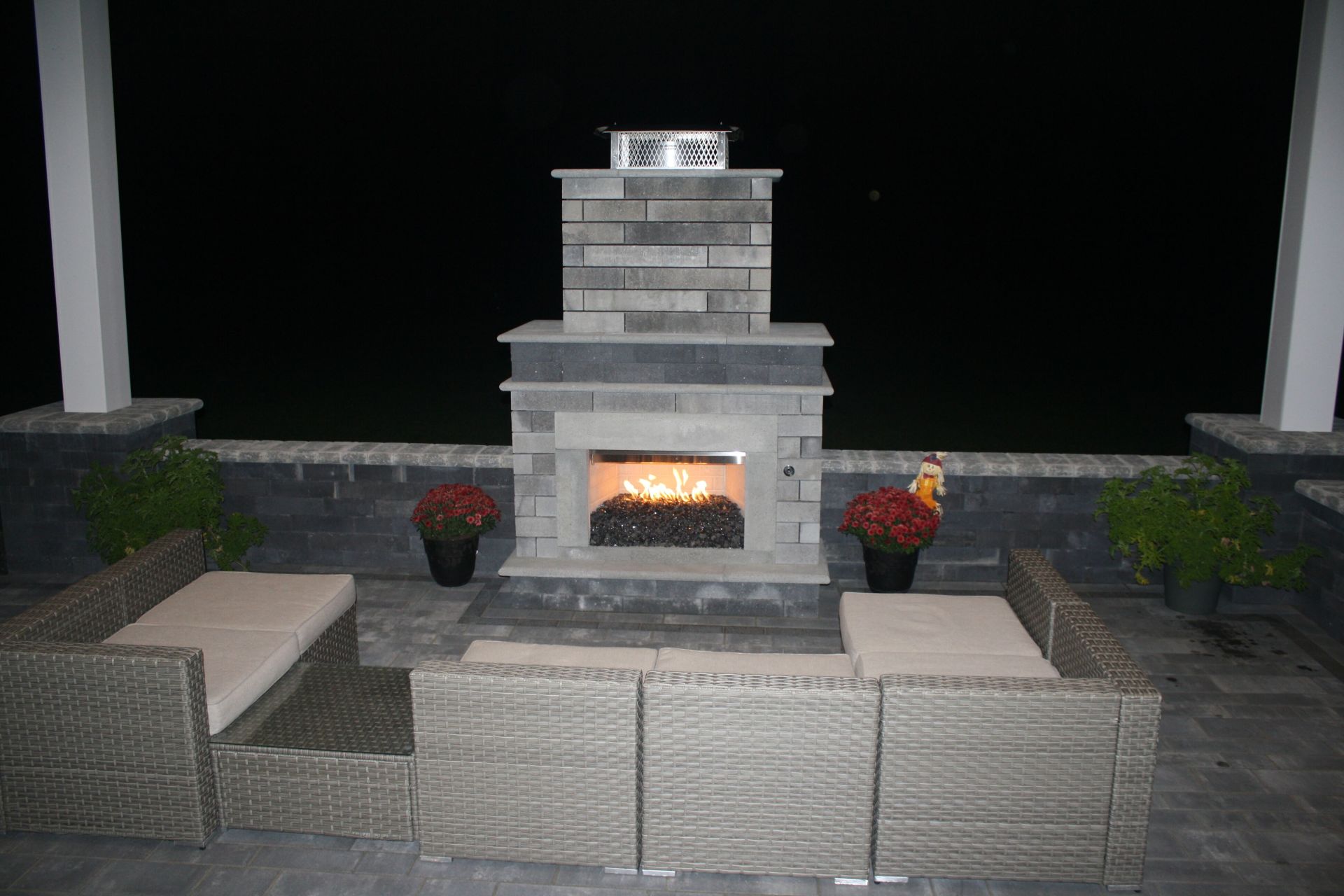 there is a fireplace in the middle of the patio .