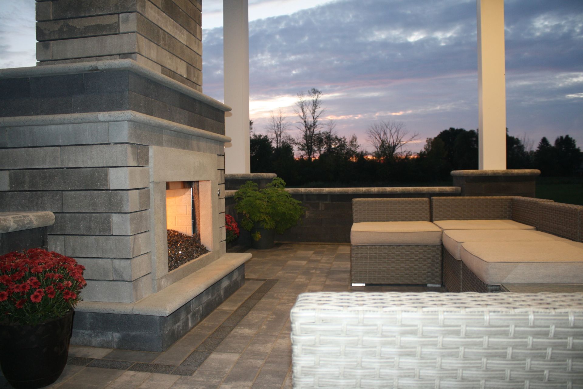 a patio with a fireplace and a couch