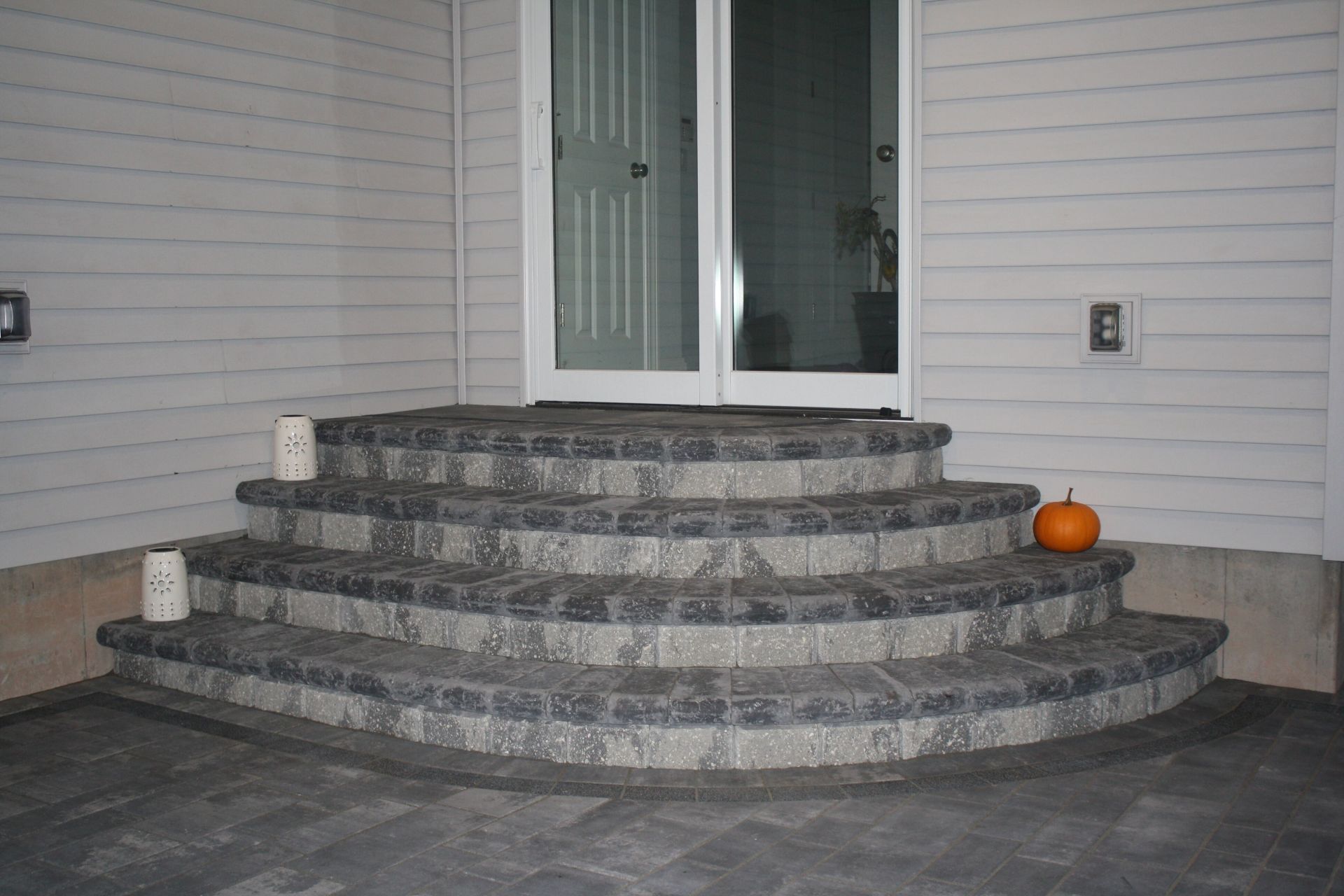 a set of stairs leading up to a door with a pumpkin on the side .