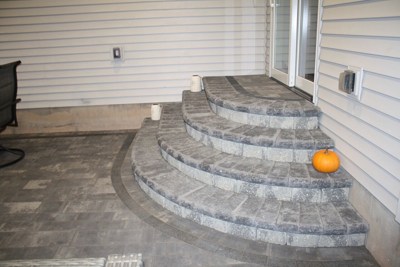 there is a pumpkin on the steps of a house .