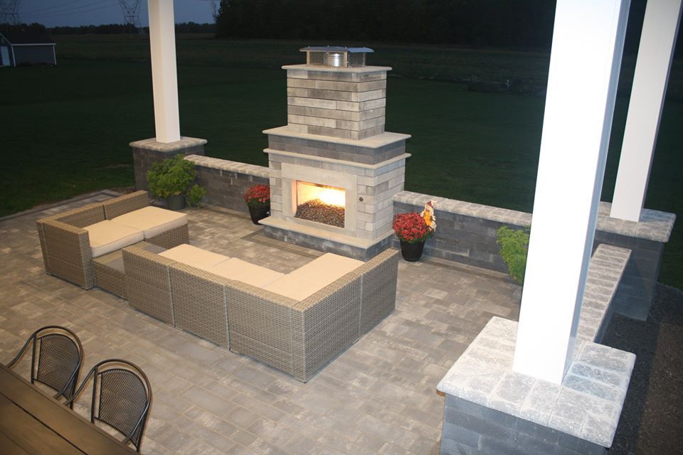 there is a fireplace in the middle of the patio .