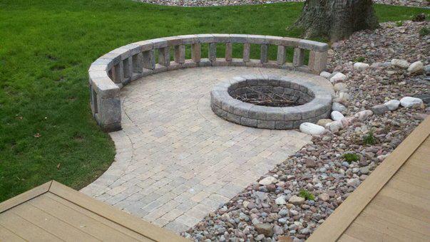 there is a fire pit in the middle of the yard .