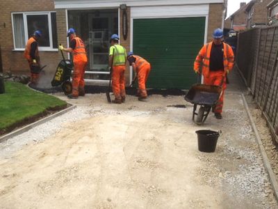 Workers laying a driveway