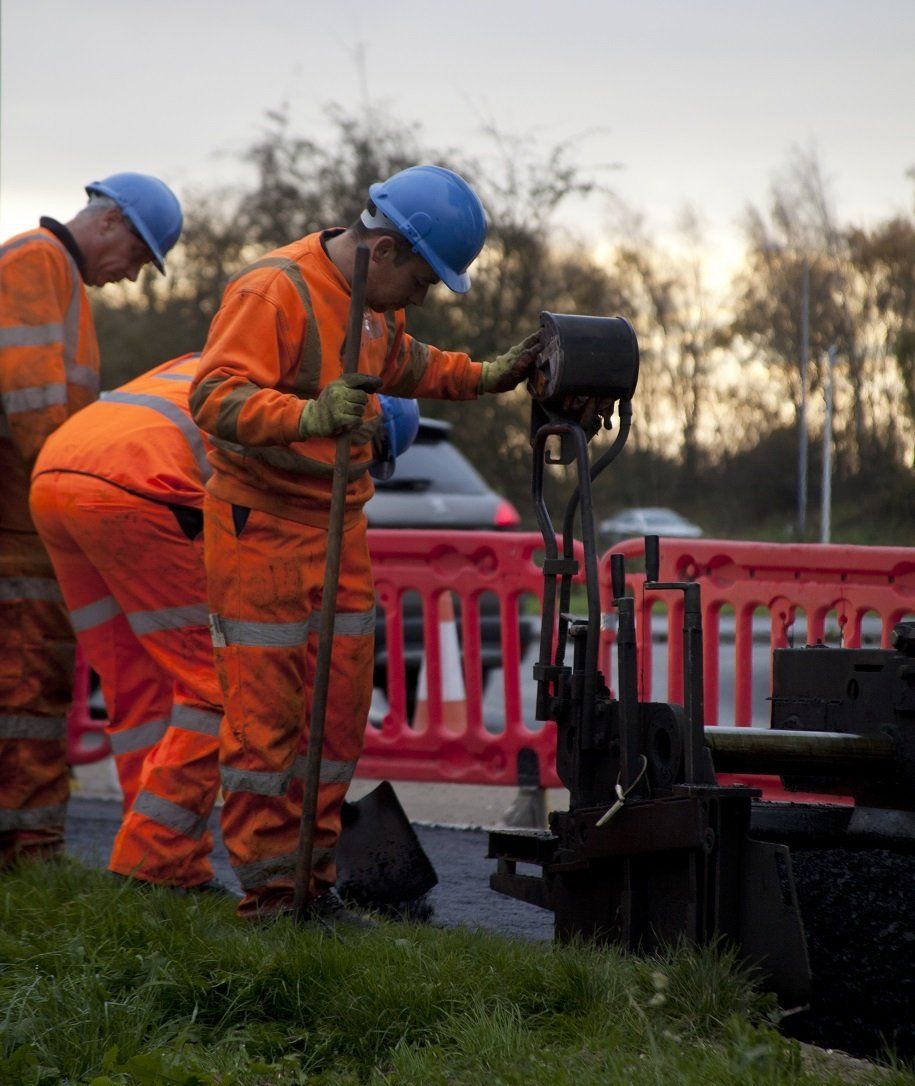 Workers around a temporary barrier
