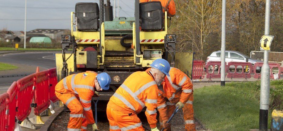 men working on a public road