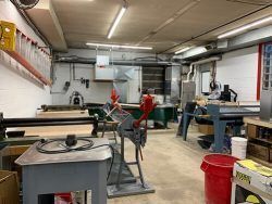 A workshop filled with lots of tools and tables.