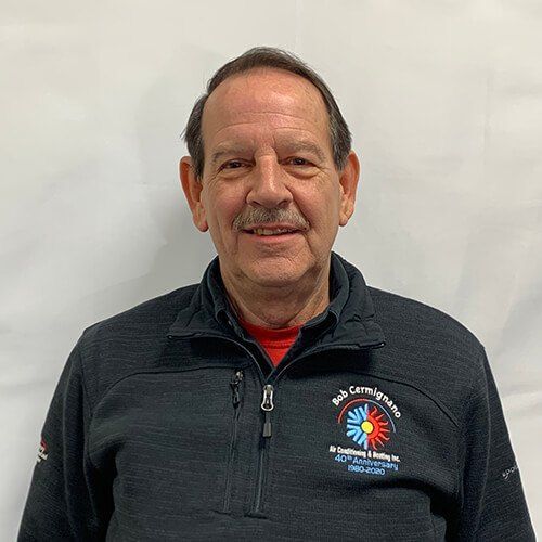 A man with a mustache is wearing a black jacket and a red shirt.