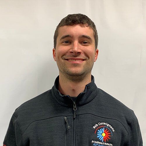 A man in a black jacket is smiling for the camera.