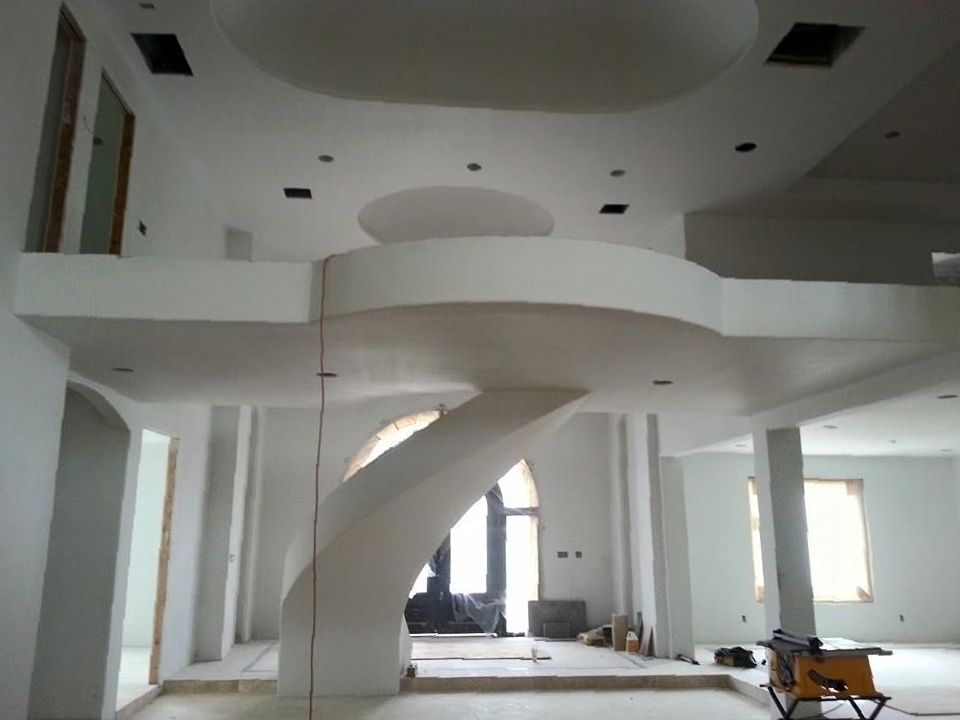A large white room with a spiral staircase in the middle