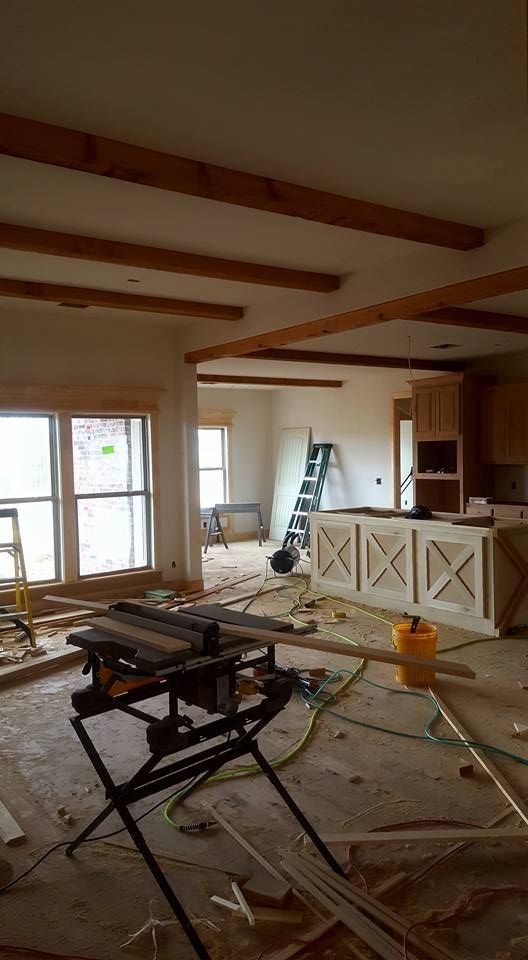 There is a table saw in the middle of the room.